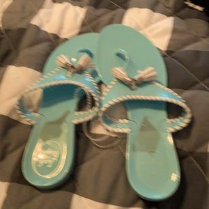 A pair of light blue jack Rogers sandals
